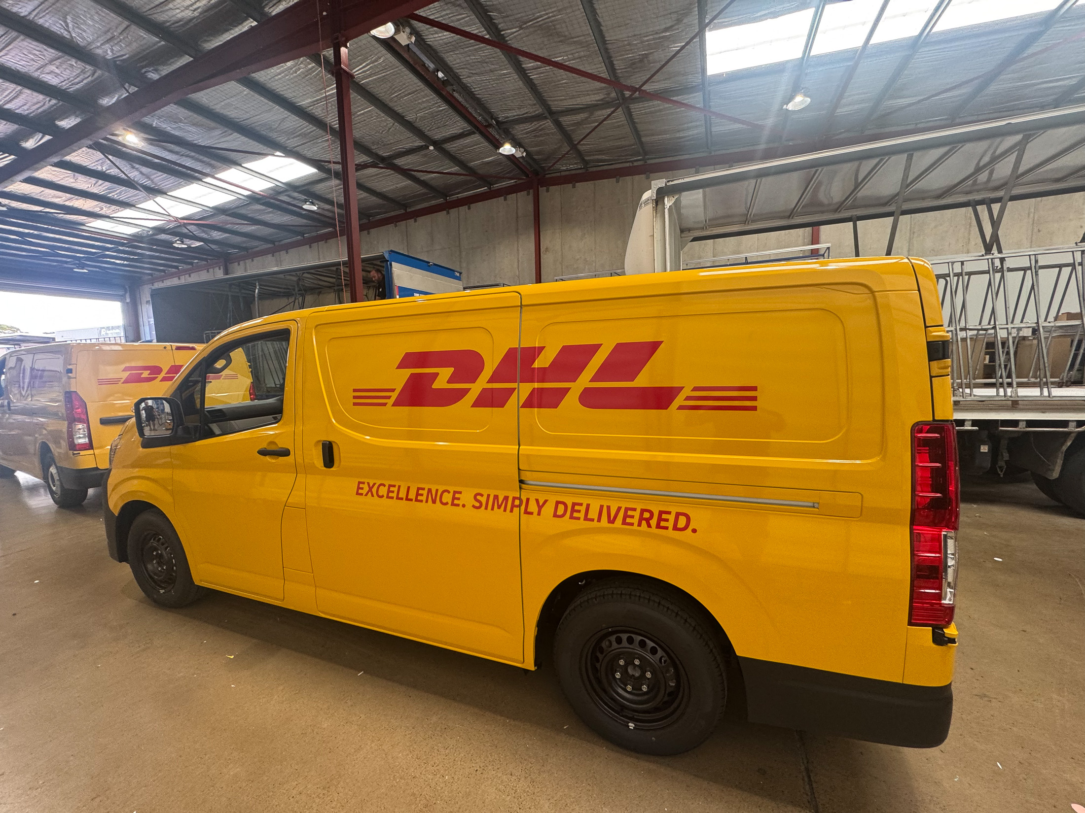 DHL Toyota Hiace with distinctive yellow paint and wrap combination