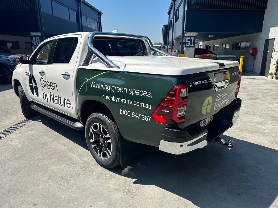 Green by Nature branded truck showcasing sustainability messaging